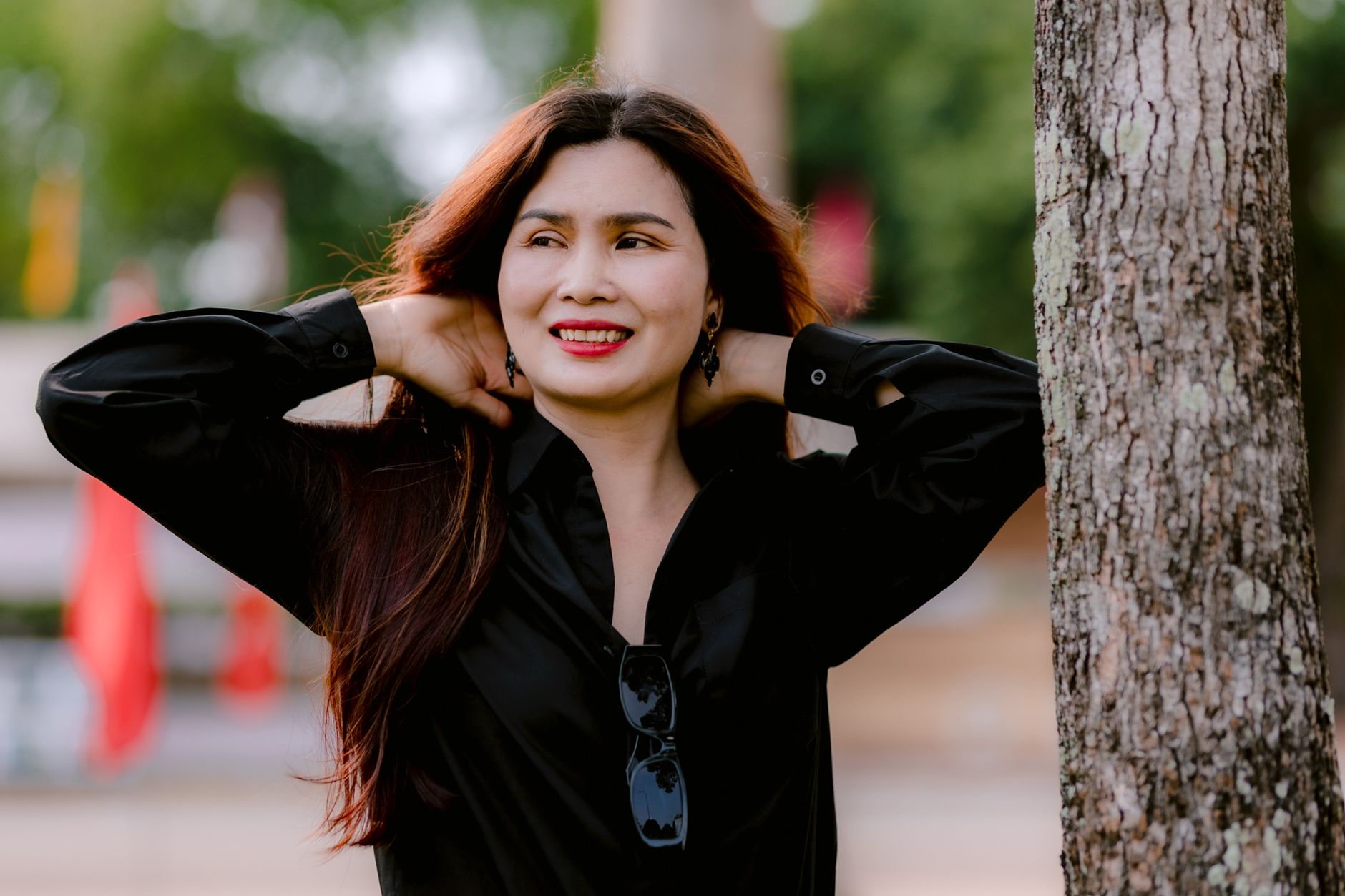 smiling woman relaxing outdoors in sunny park